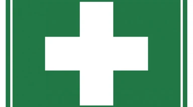 First aid sign with white cross on green background